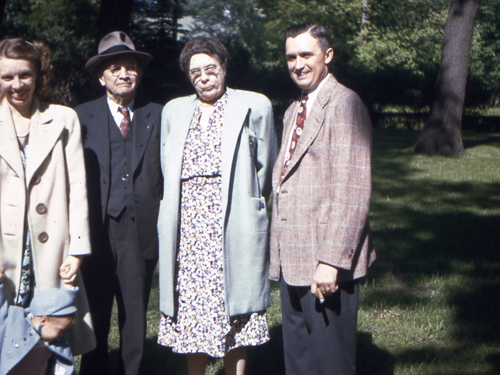 Mildred holding Bob, Jr.s hand, Harry F. and Jenny Gross, with Harry holding trademark cigar.